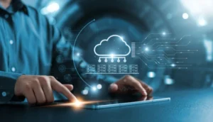 A person uses a tablet with a glowing cloud computing icon and digital data graphics hovering above