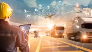 Logistics manager using a tablet to monitor a fleet of connected trucks on a highway with digital tracking icons overlayed