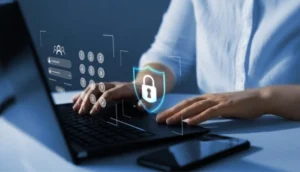 A person types on a laptop with floating digital icons of a lock, keypad, and user login