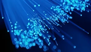 Close-up view of glowing blue fiber optic strands against a dark background