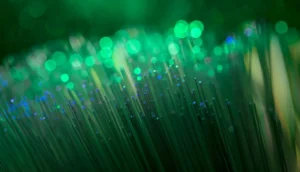 Close-up of glowing green fiber optic strands