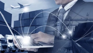 Business professional using a laptop with digital network lines overlaying a backdrop of cargo containers, trucks, ships