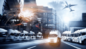 image showing a businessman using a tablet overlaid on a busy logistics hub with trucks, shipping containers