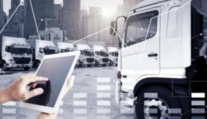 Person using a tablet to manage a fleet of trucks with digital interface overlays