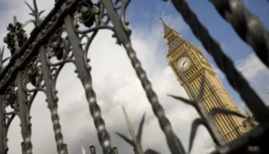 The Elizabeth Tower, commonly known as Big Ben, is seen through ornate black railings